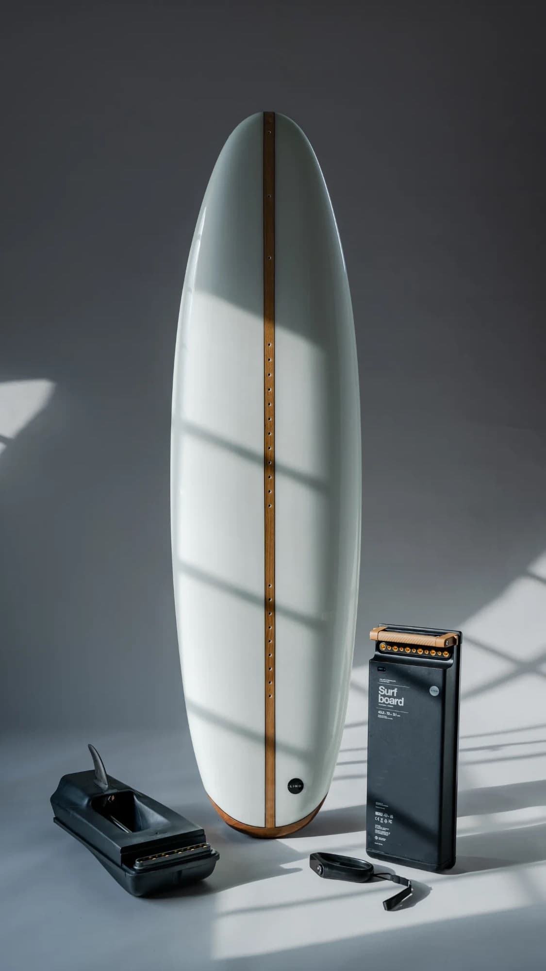 Lind board standing in window light with its jet drive, leash and battery